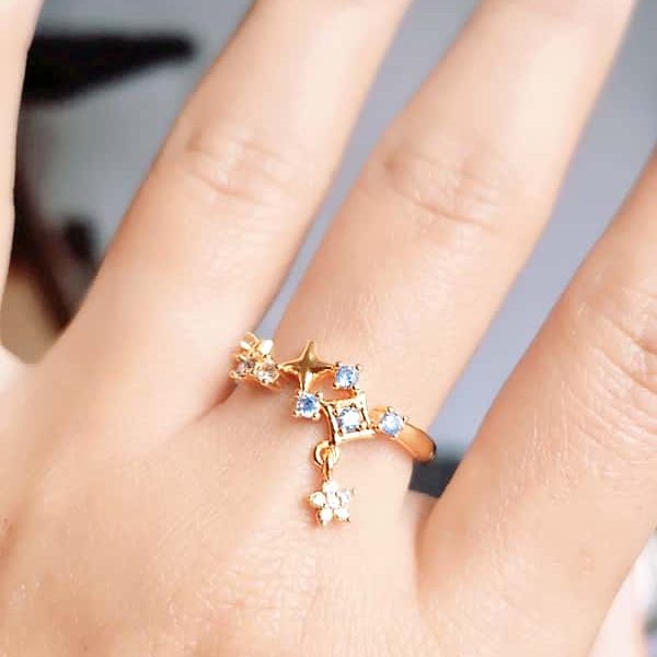 Goldener Ring mit blauen Kristallen und Sternanhänger